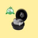 Black Leaf Steely Dan Edelstahl-Grinder in a black case with yellow background and green grow island logog in the right upper corner