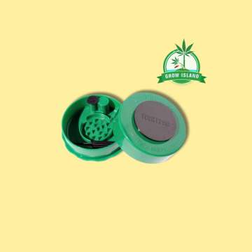 one opened green grinder from GrinderVac with yellow background and green Grow Island logo in the right upper corner